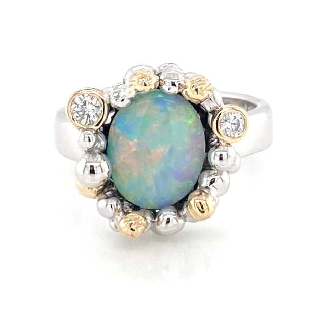 Opal ring i sølv og guld, med solid crystal opal
Opalen er oval og er indfattet med kugler hele vejen omkring opalen som er pastelle farver
