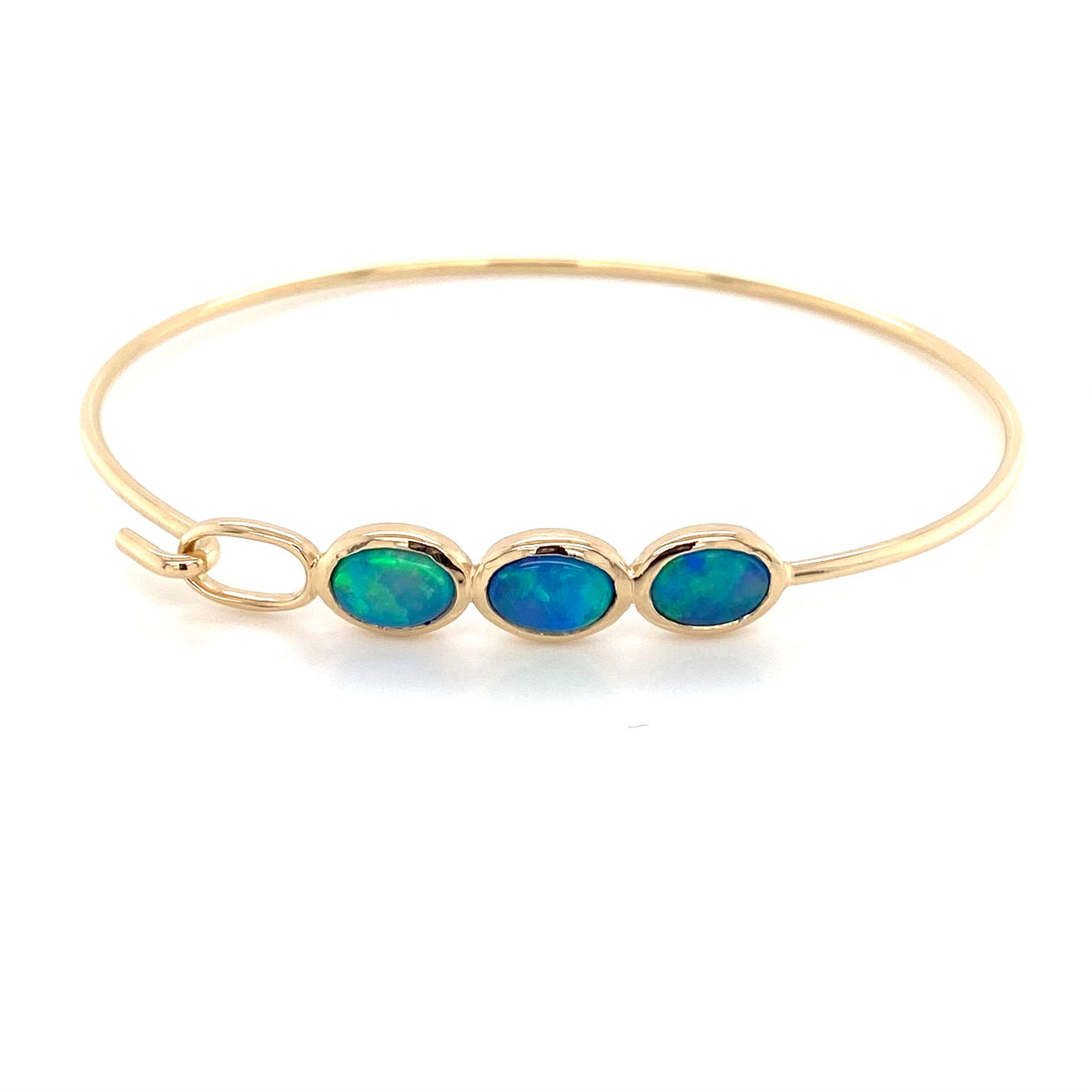 Armring i 14 karat guld med 3 stk. 7 x 5 mm solid krystal opaler fra Australien.