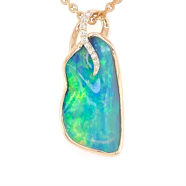 Opal vedhænget har en ægte solid Australsk krystal opal som er indfattet i 14 karat guld. Opalen er 5,38 ct. Med 10 brilliant diamanter 0,07 ct. W/SI.