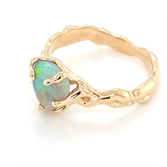 Ring med ægte solid crystal opal fra Lightning Ridge, Australien. Opalen er indfattet 14 karat guld. Krogede rustikke grene af 14 karat guld holder opalen på plads. Opalen vejer 1,35 ct.