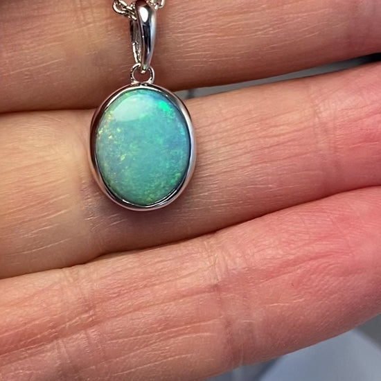 Vedhæng med en ægte solid krystal opal fra Australien indfattet i rhodineret sterling sølv.