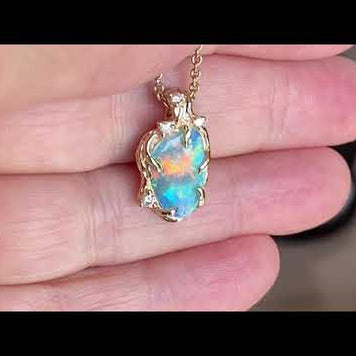 Ægte solid crystal opal fra Australien indfattet i 14 karat guld. De krogede rustikke grene af 14 karat guld holder opalen på plads. Opalen vejer 1,41 ct. Smykket har i alt 4 brillianter: 1x 0,02 ct., 1x 0,03 ct. og 2x 0,015 ct. i W/SI.