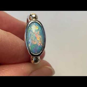Ægte solid crystal opal fra Australien indfattet i sterling sølv med 14 karat guld detaljer.