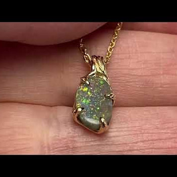 Vedhæng med en ægte solid crystal opal fra vores egen mine i Lightning Ridge, Australien. Indfattet i 14 karat rustikt guld. De krogede rustikke grene af 14 karat guld holder opalen på plads. Opalen vejer 1,07 ct., og har N6 bodytone.