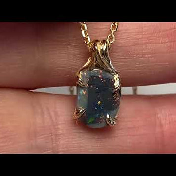Vedhæng med en ægte solid crystal opal fra vores egen mine i Lightning Ridge, Australien. Indfattet i 14 karat rustikt guld. De krogede rustikke grene af 14 karat guld holder opalen på plads. Opalen vejer 1,15 ct., og har N3-N7 bodytone.