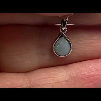 Vedhæng med en ægte solid krystal opal fra Australien indfattet i blankt rhodineret sterling sølv.