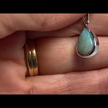 Vedhæng med en ægte solid krystal opal fra Australien indfattet i rhodineret sterling sølv.