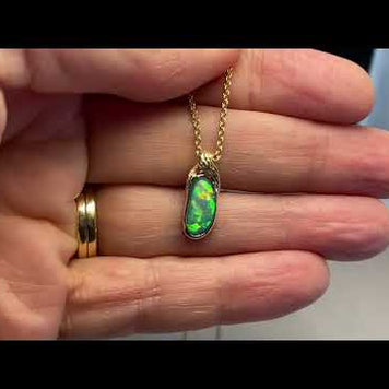 Vedhæng med en ægte solid krystal opal fra Australien indfattet i 14 karat guld. Opalen er 0,88 ct.